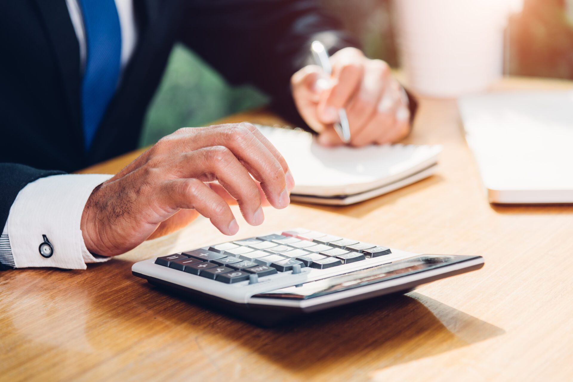 Business man accounting using calculating and work with laptop computer on desk office, finance concept